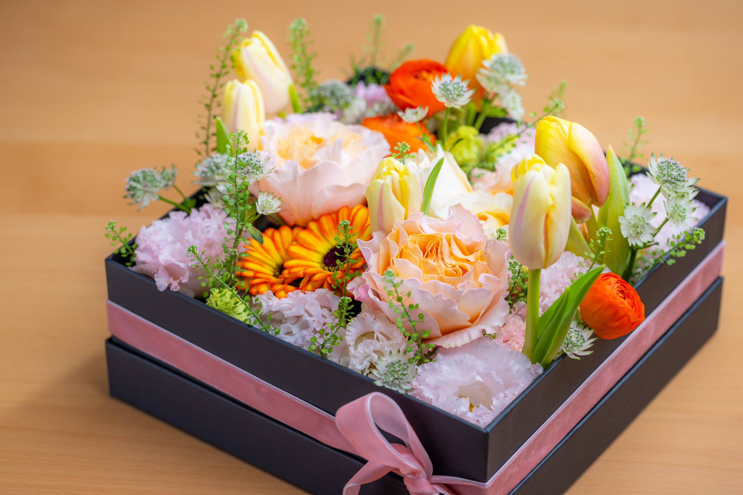 Box of different flower on the table